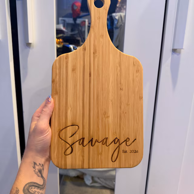 Real customer photo of a personalized engraved cutting board